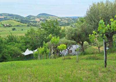 The landscape of Le Marche as seen from camping Le Farfalle, just above one of the camping spots showing a camper